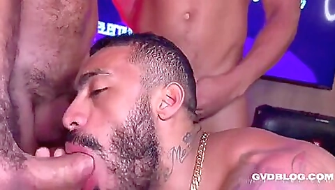 Tattooed guy is riding his cock in a group threesome